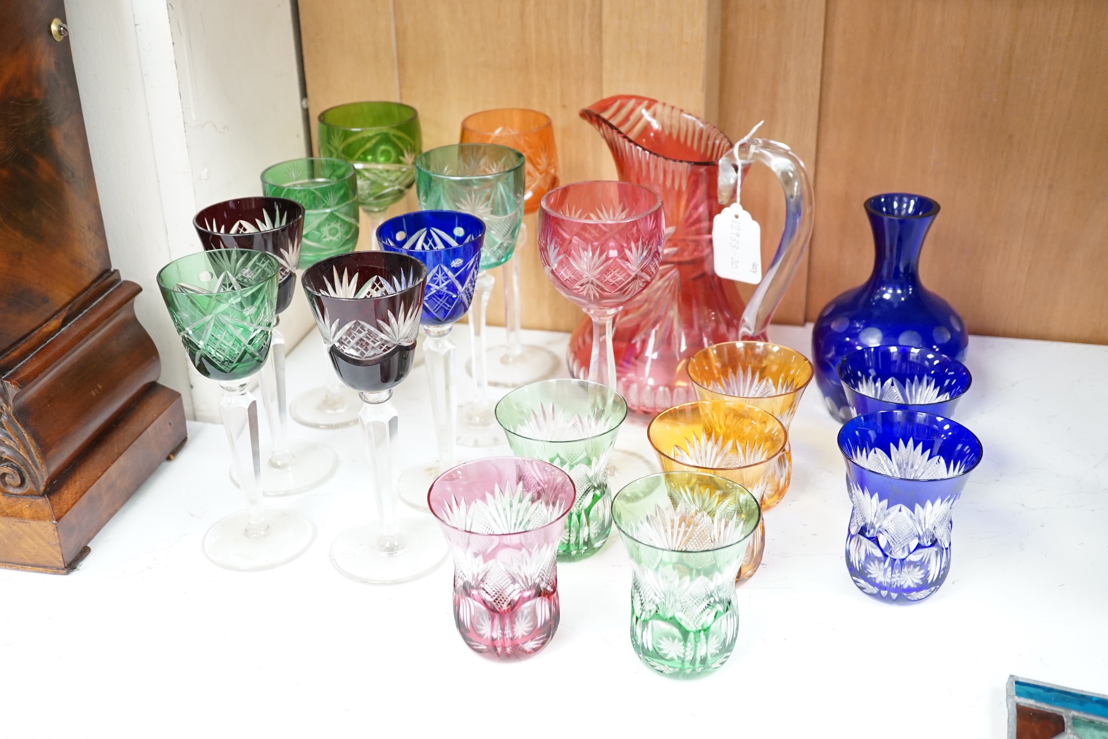 A group of eleven colour flashed hock glasses, a jug, vase and nine tumblers
